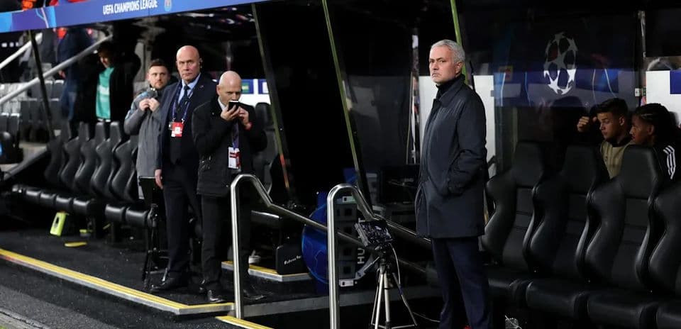 Manager observing from the dugout during match