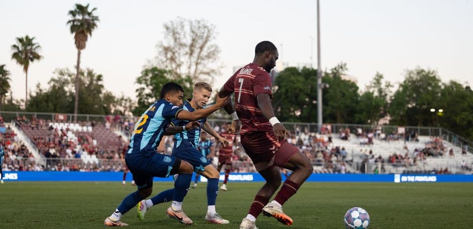 Two players competing for the ball during football match