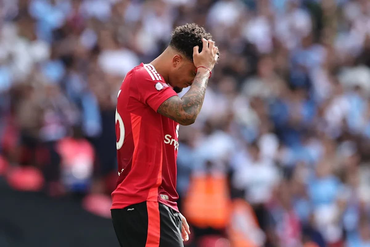 Player in red jersey holding head in disappointment