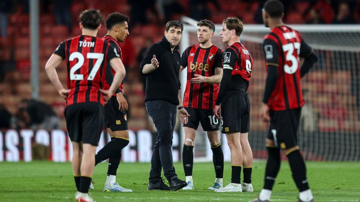 Bournemouth players discussing strategy with coach