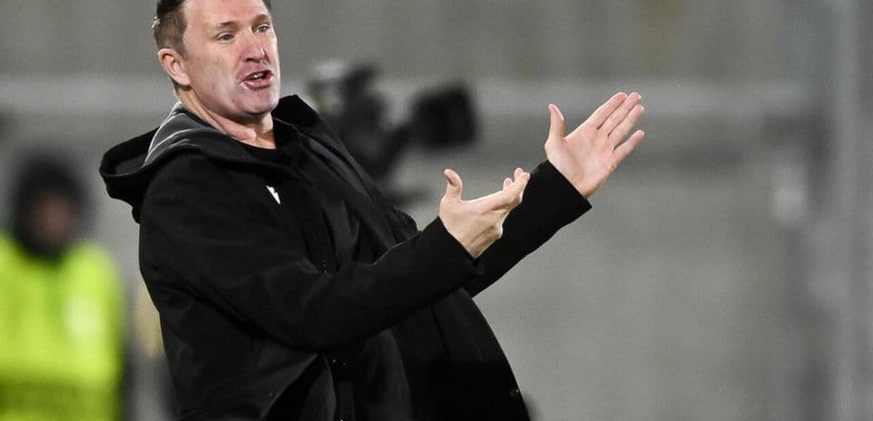 Coach gesturing during a football match