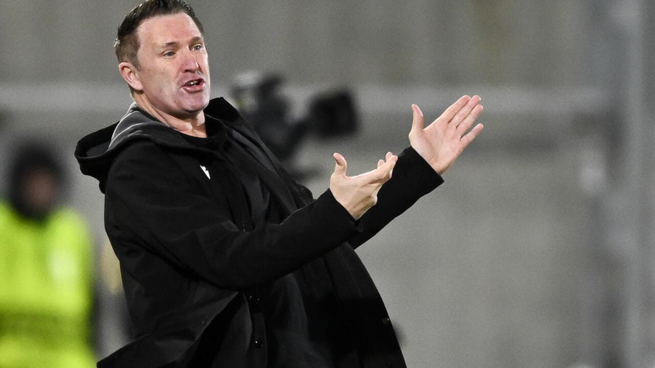 Coach gesturing during a football match