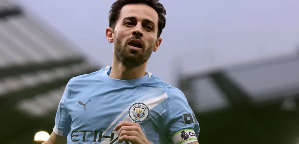 Player running in Manchester City kit during match