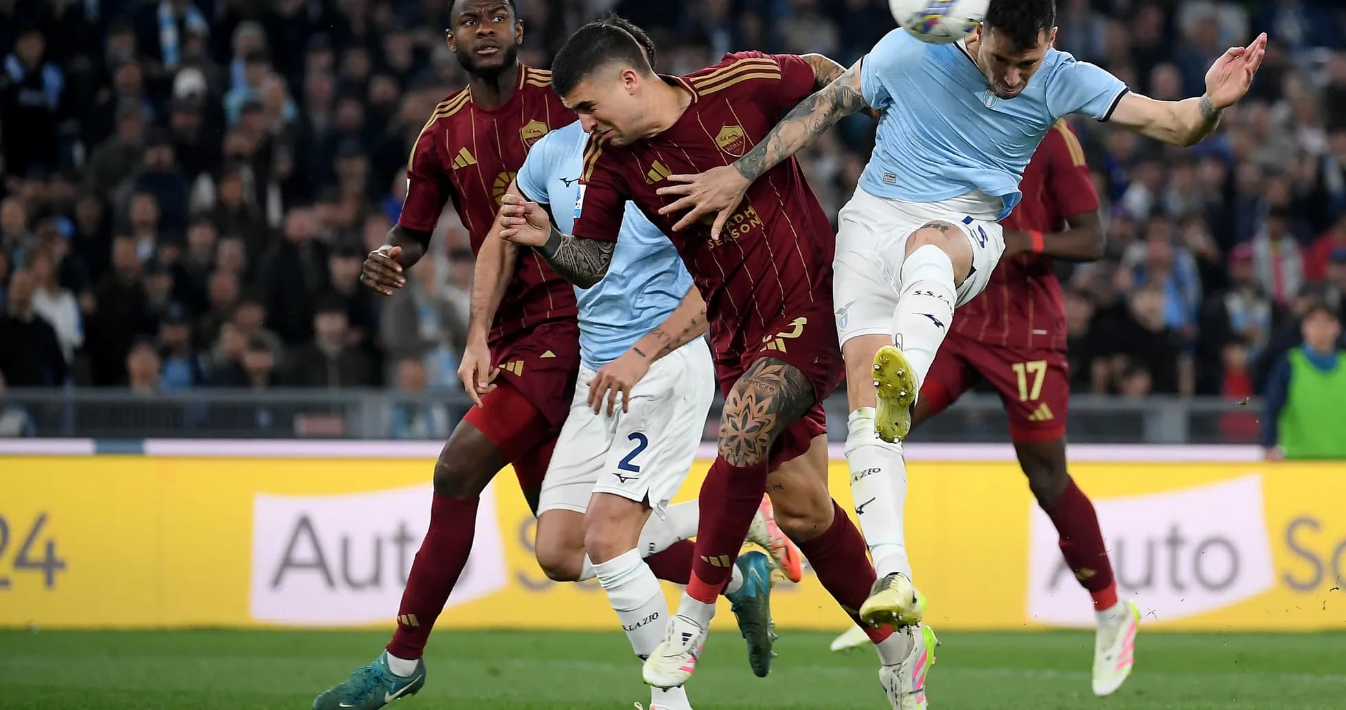 AS Roma players contesting a header against Lazio