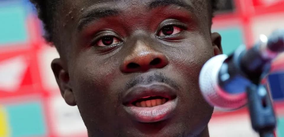 Player speaking at press conference with microphone