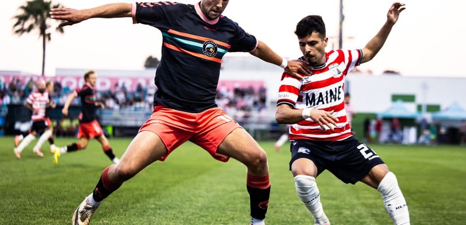 Players competing for the ball during USL match
