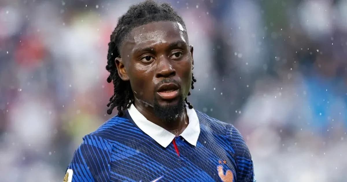 Player in blue France jersey during rainy match