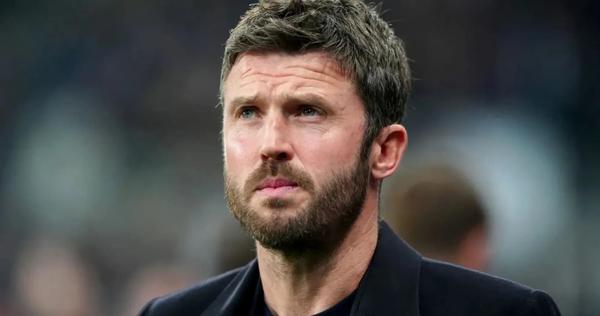 Man with beard looking intently off-camera