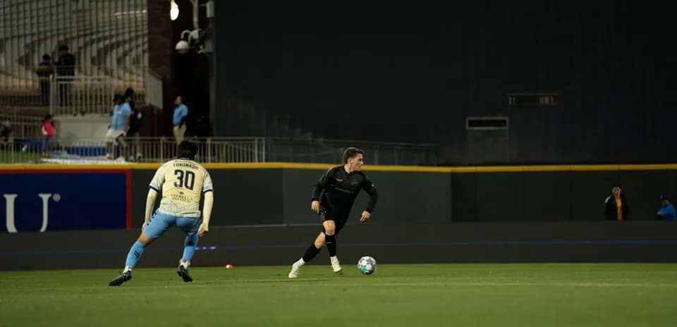 Player dribbling the ball during USL match
