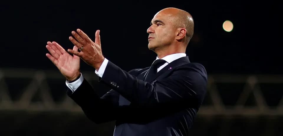 Coach applauding during a match from the sidelines