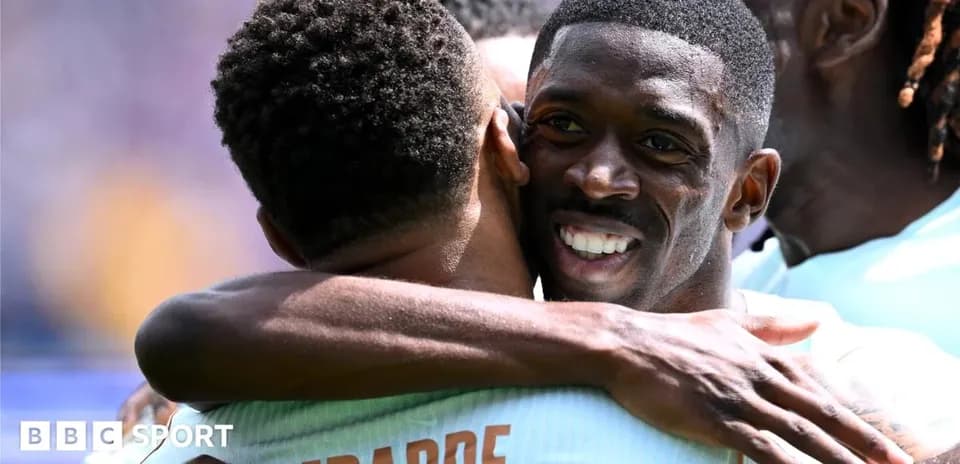 Two players celebrating with an embrace on field