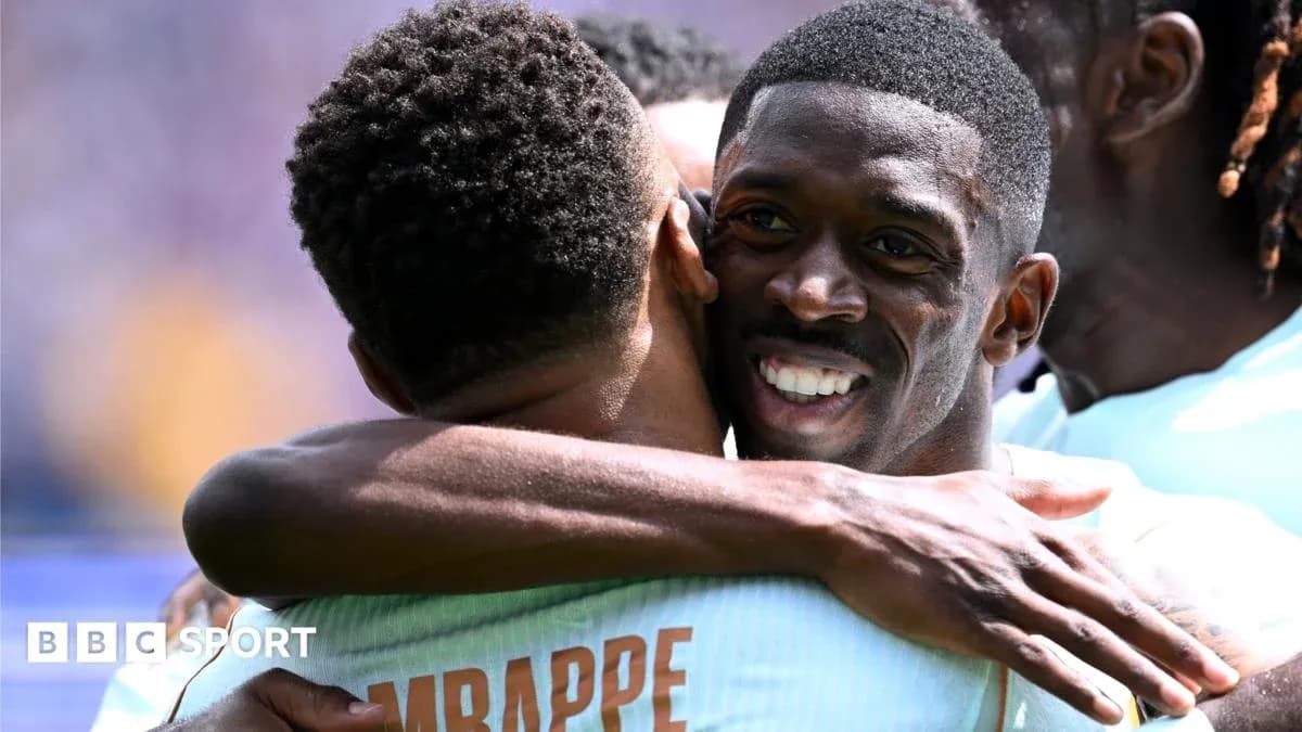 Two players celebrating with an embrace on field