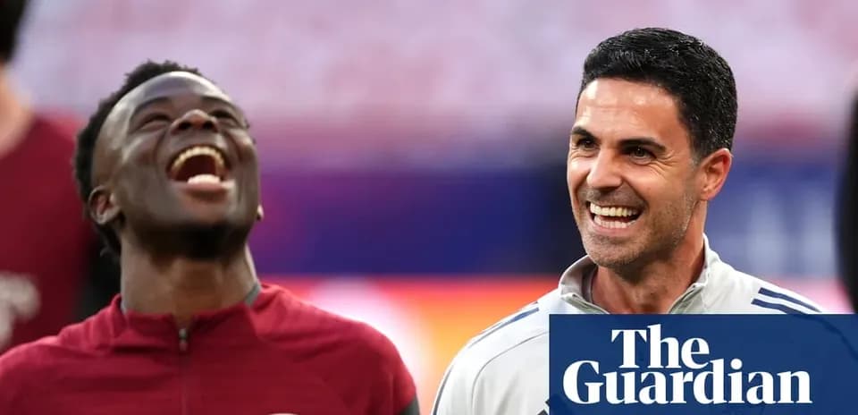 Two Arsenal team members smiling during warm-up
