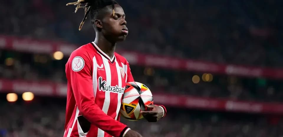 Player in red jersey holding a soccer ball