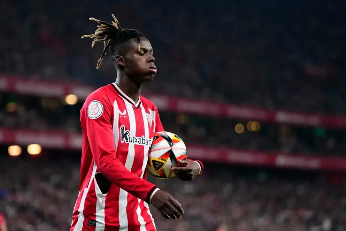 Player in red jersey holding a soccer ball