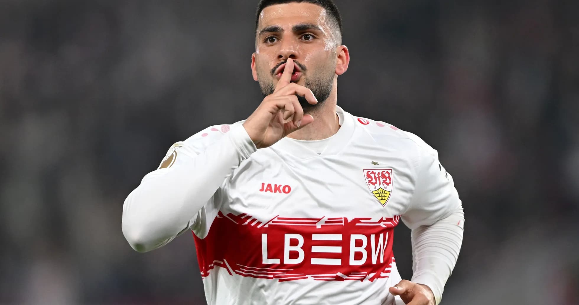 Player celebrating with shushing gesture after scoring