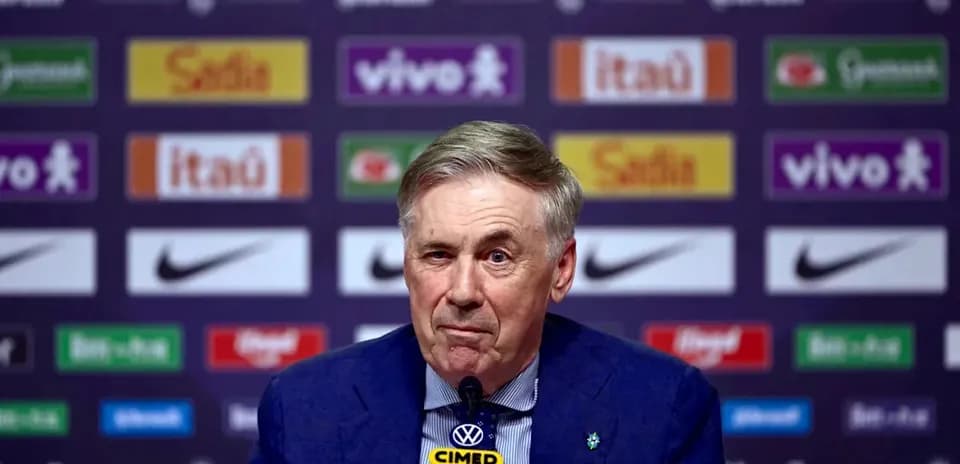 Manager speaking at press conference with sponsor logos