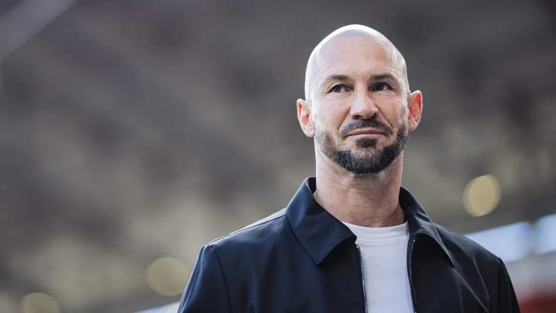 Man with beard in black jacket outdoors