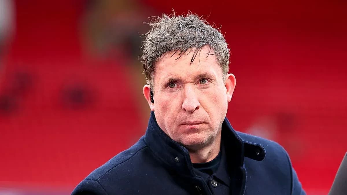 Man in coat with ear piece at stadium