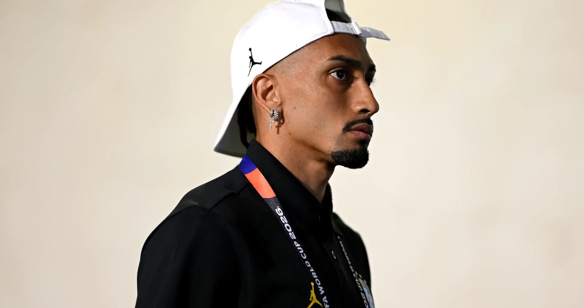 Person wearing cap and lanyard, side profile