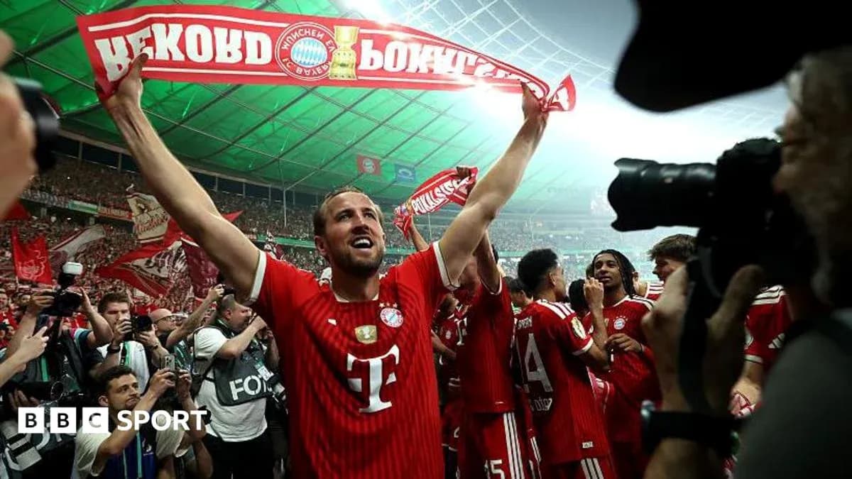Player celebrating with scarf in packed stadium