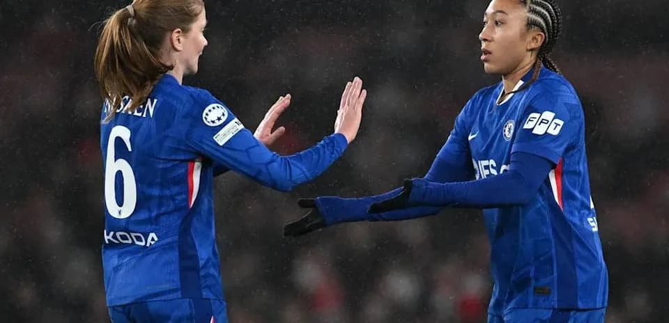 Two Chelsea players exchanging a handshake on field