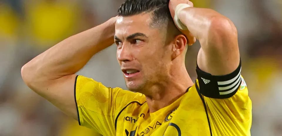 Player in yellow jersey holding head in frustration