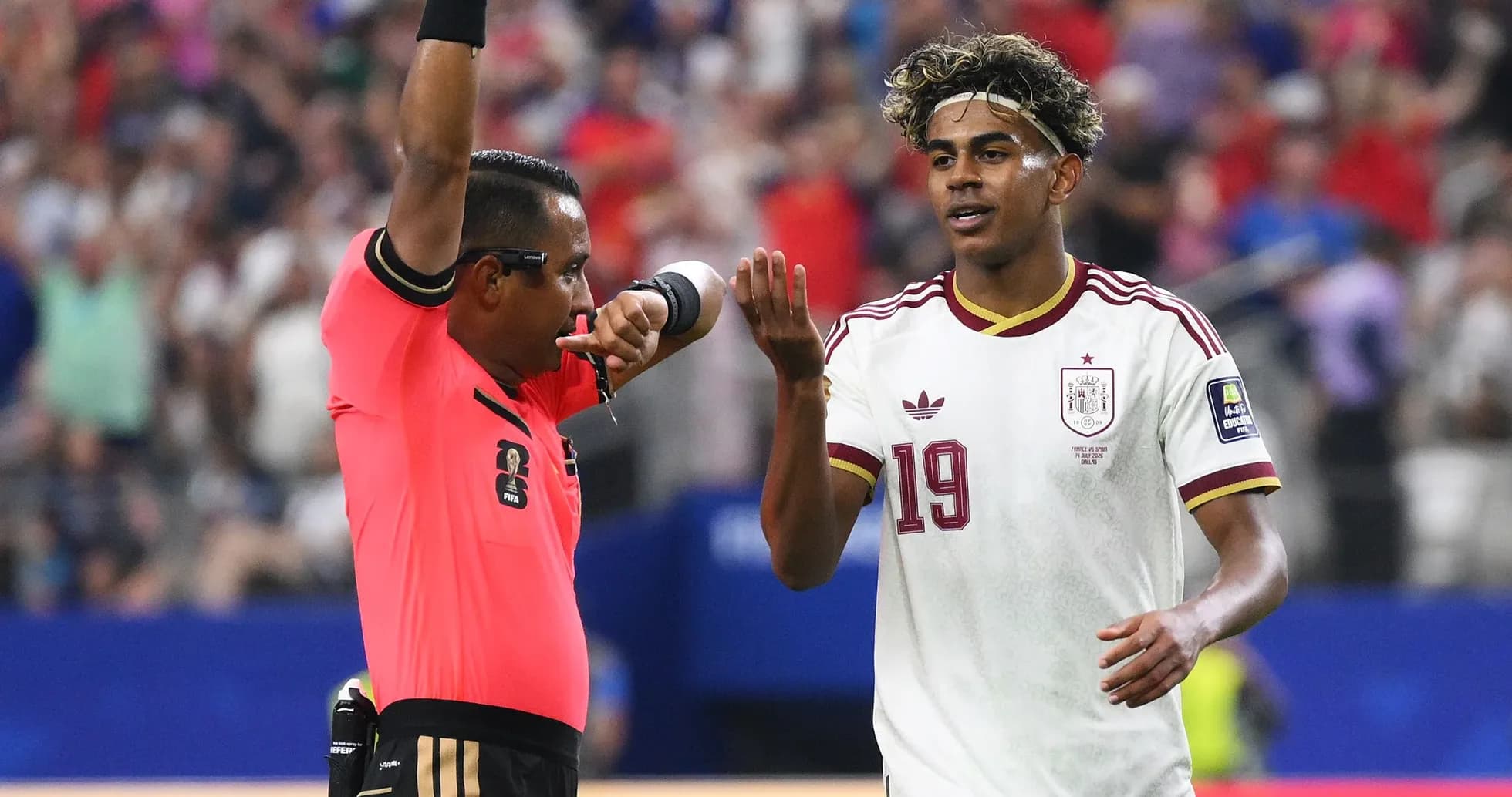 Referee showing a card to Spanish player during match
