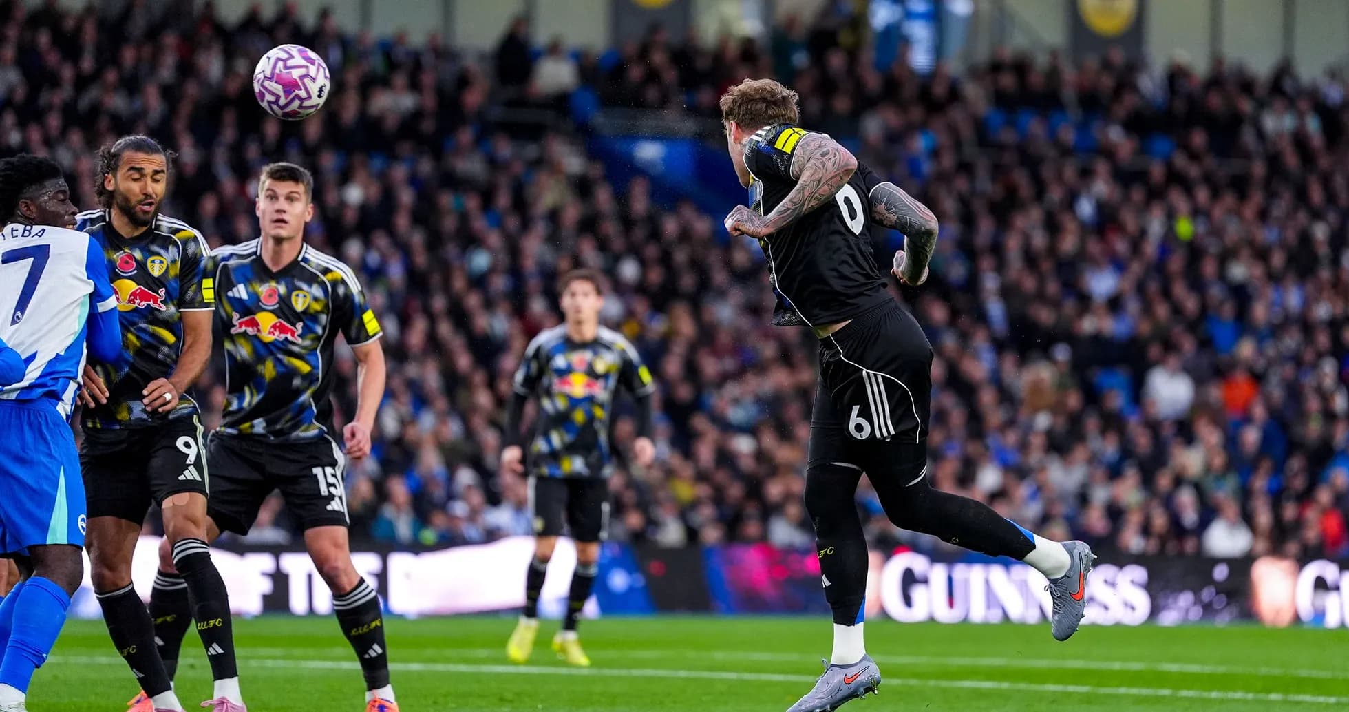 Leeds player heading ball during match against Brighton