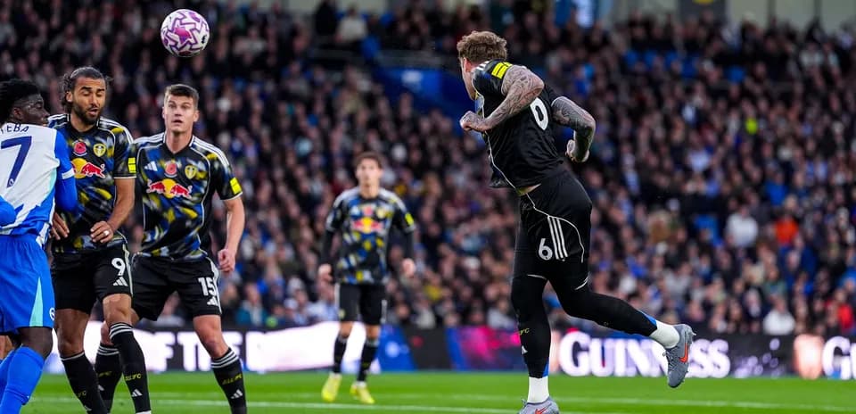 Leeds player heading ball during match against Brighton