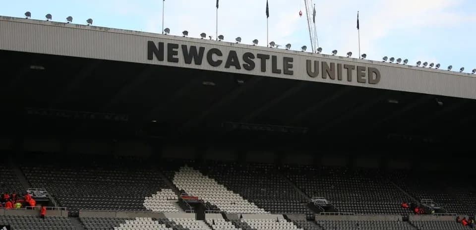 Stadium seating with Newcastle United signage overhead