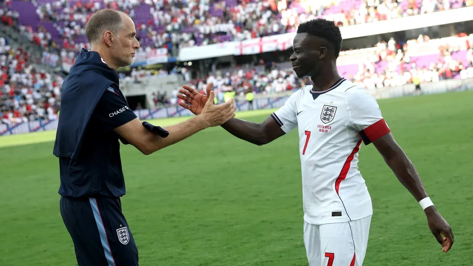 Coach and player shaking hands on field