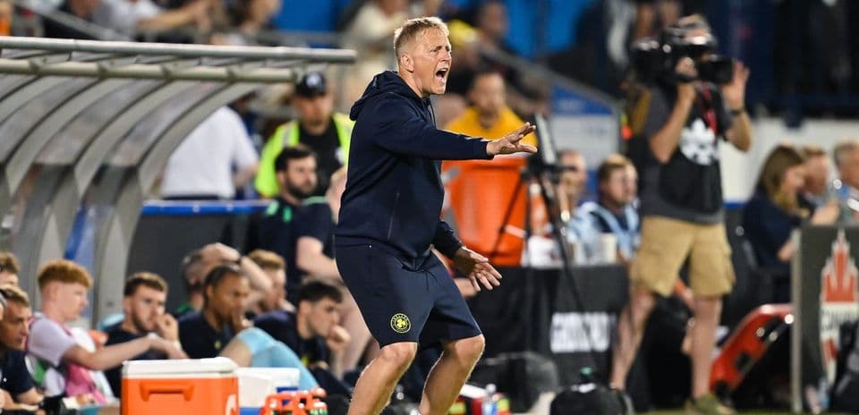 Coach directing players from the sideline during match