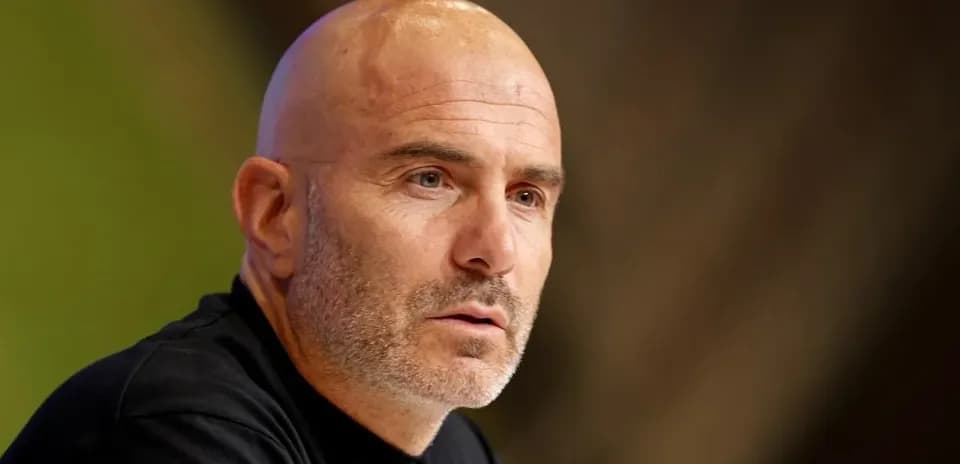 Coach speaking at a press conference