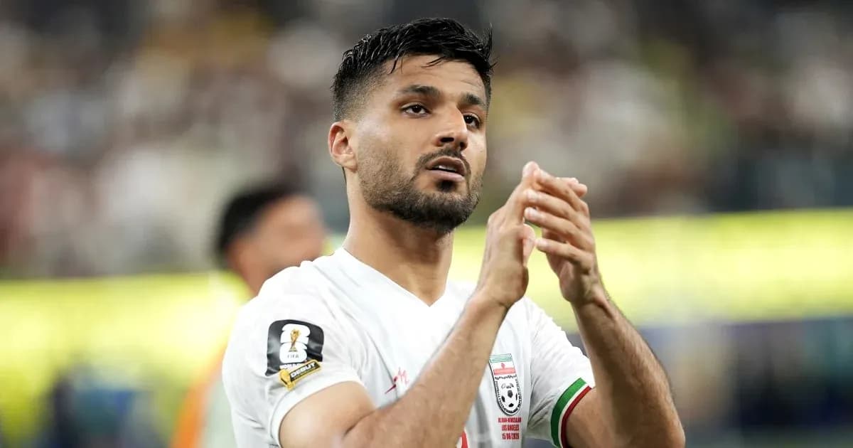 Player applauding fans during a football match