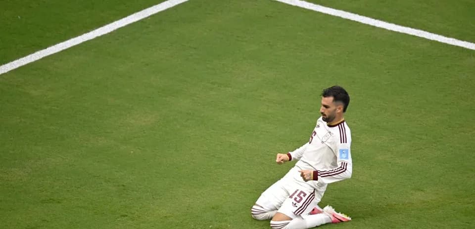 Player celebrating on the pitch after scoring goal
