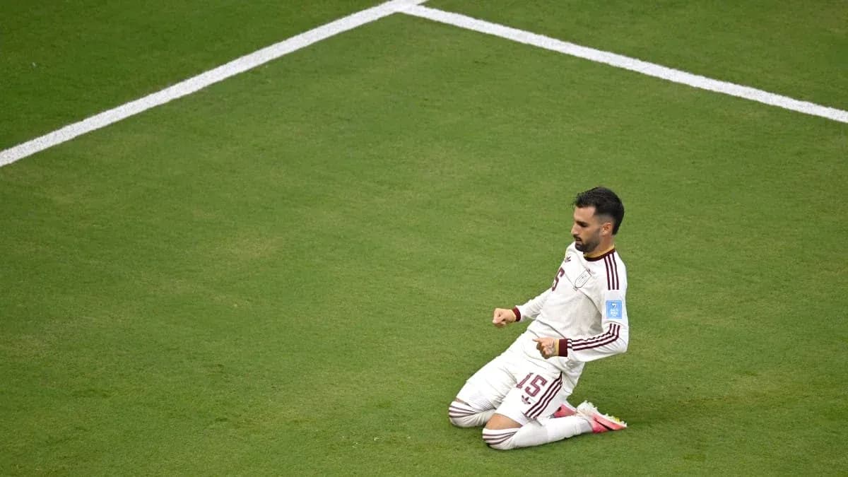 Player celebrating on the pitch after scoring goal