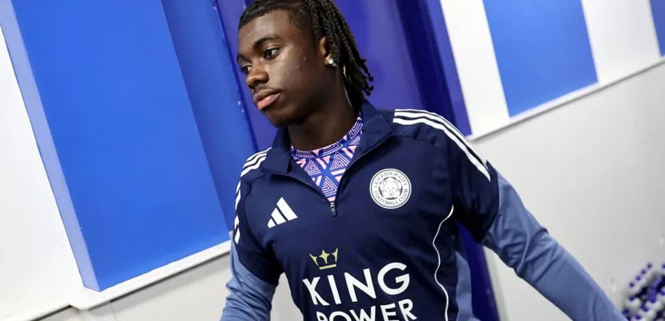 Player wearing Leicester City training kit in hallway