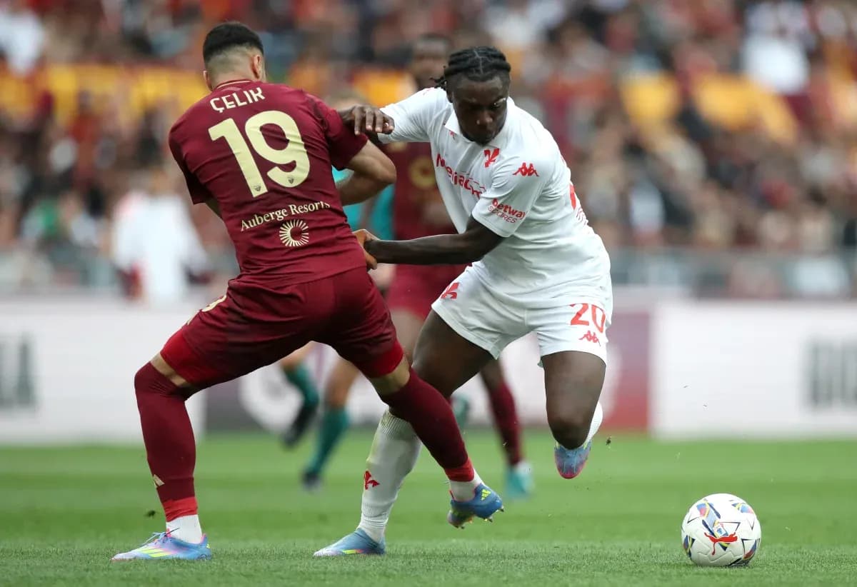 Celik and player competing for the ball