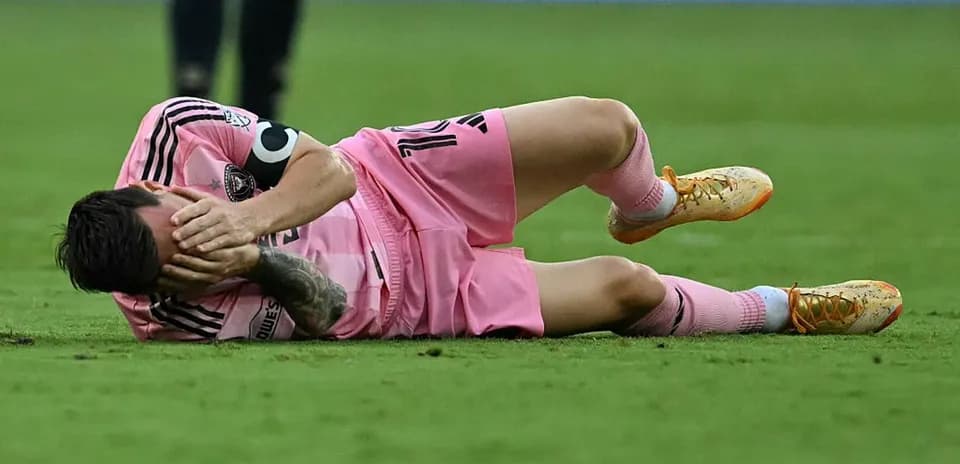 Player lying on the field, holding his face