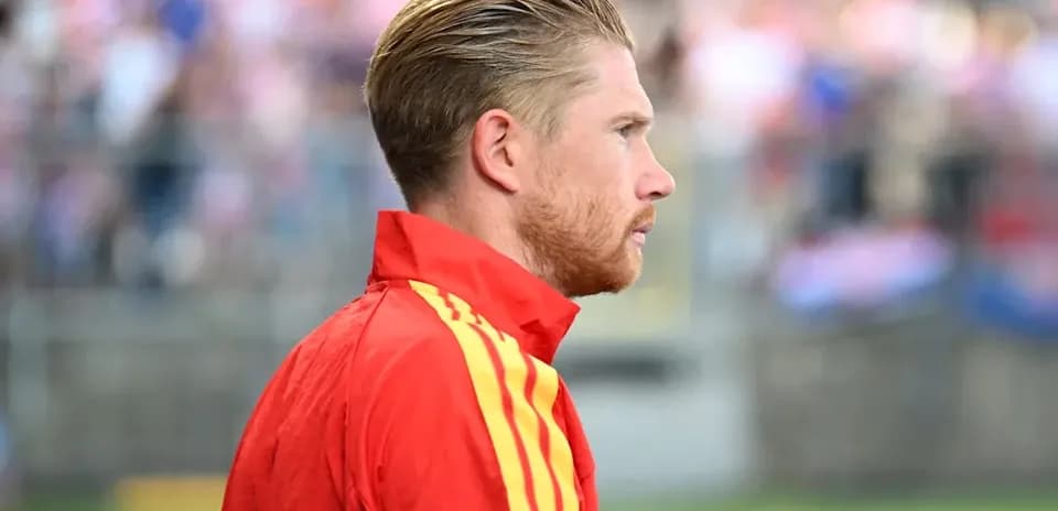 Player in red tracksuit during warm-up
