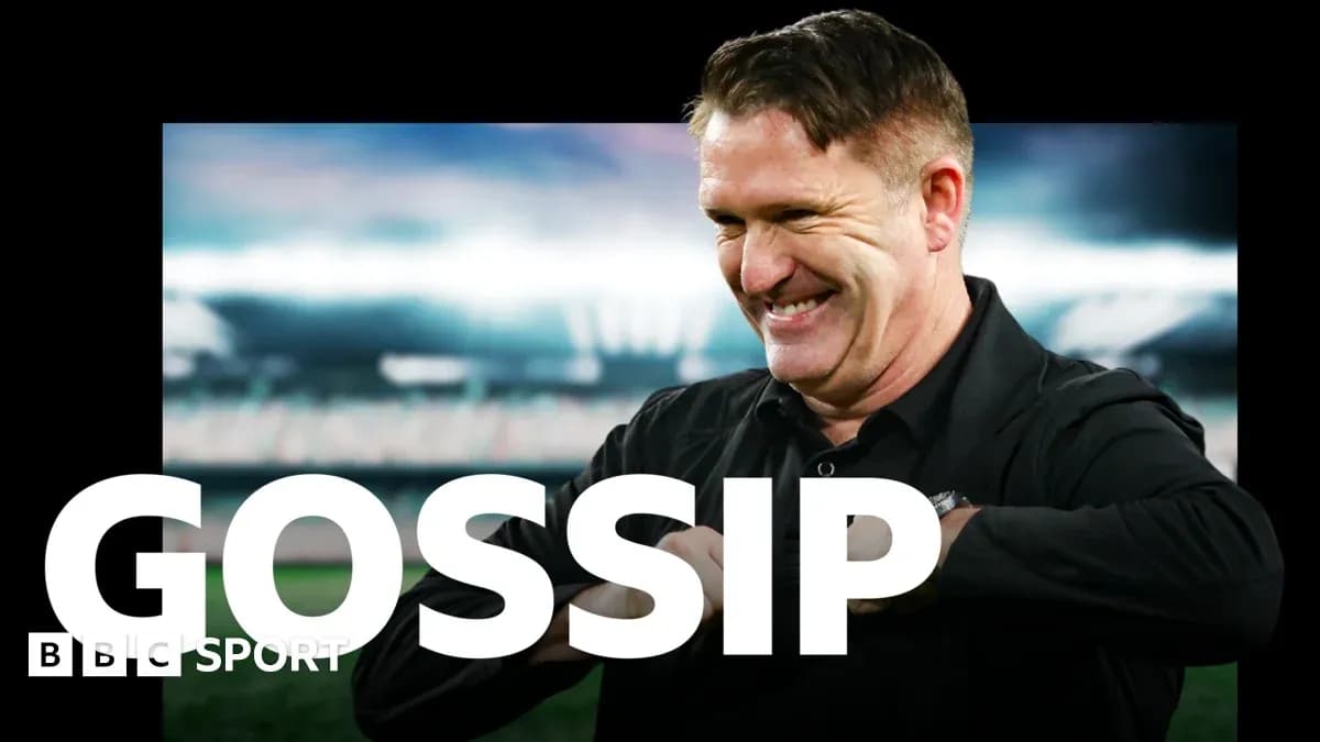 Man smiling in front of a stadium backdrop