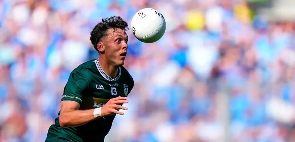 Player catching a Gaelic football during match