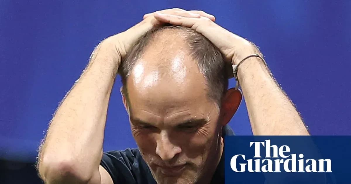 Coach with hands on head during match