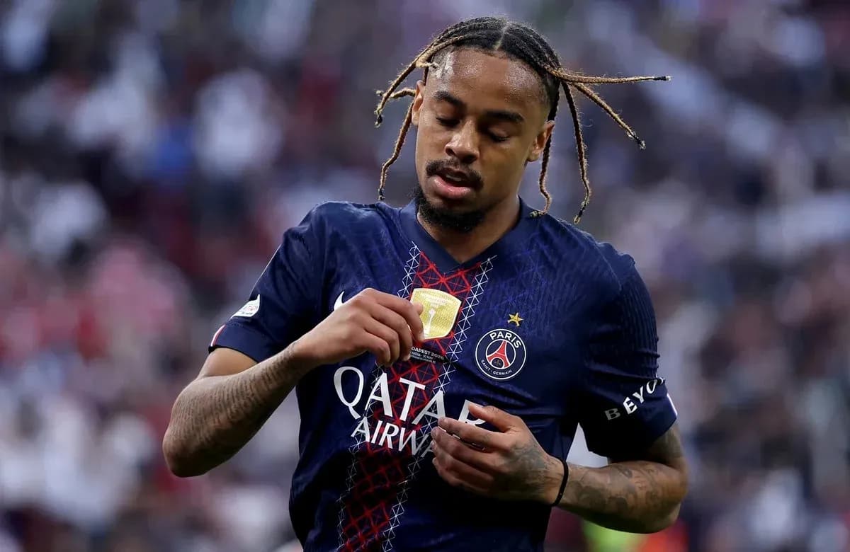 Player inspecting medal while wearing PSG jersey