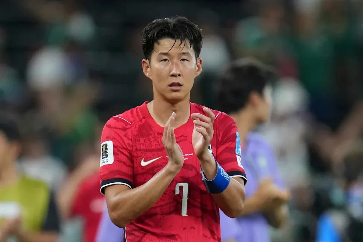 Player in red jersey applauding after match