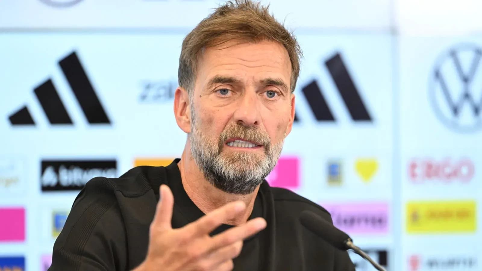 Manager speaking at press conference with microphone
