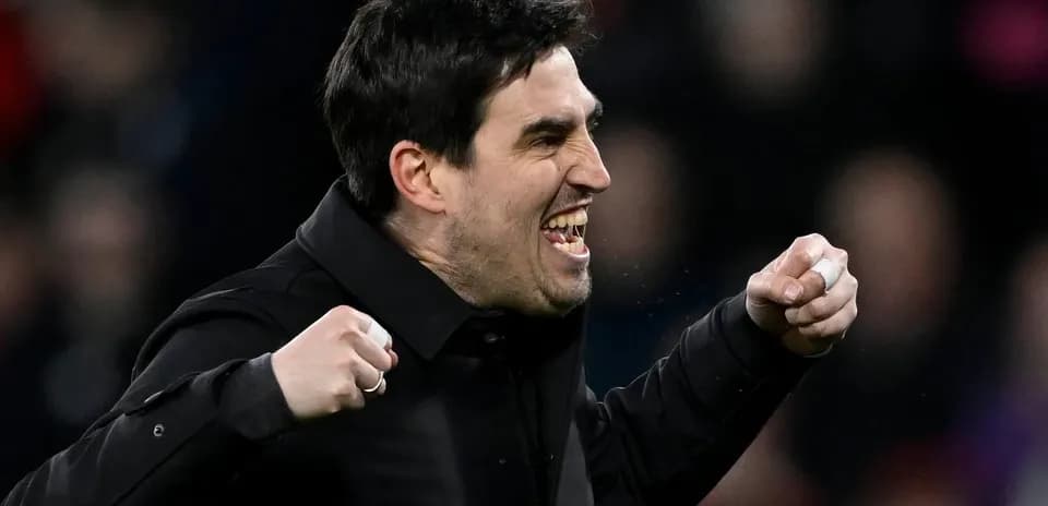 Coach celebrating a goal with clenched fists