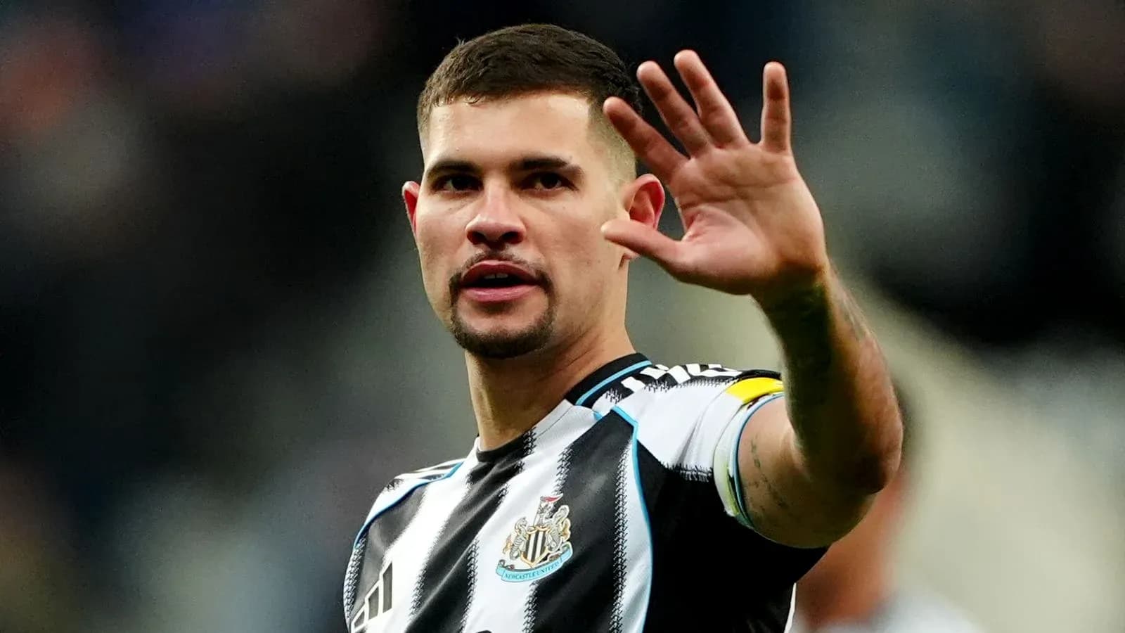 Player waving to fans during match celebration