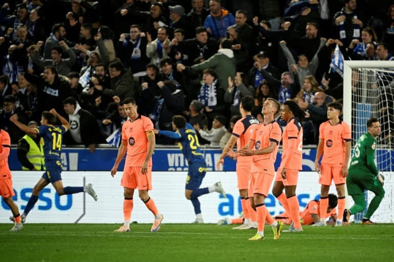 Players reacting to a goal with fans celebrating
